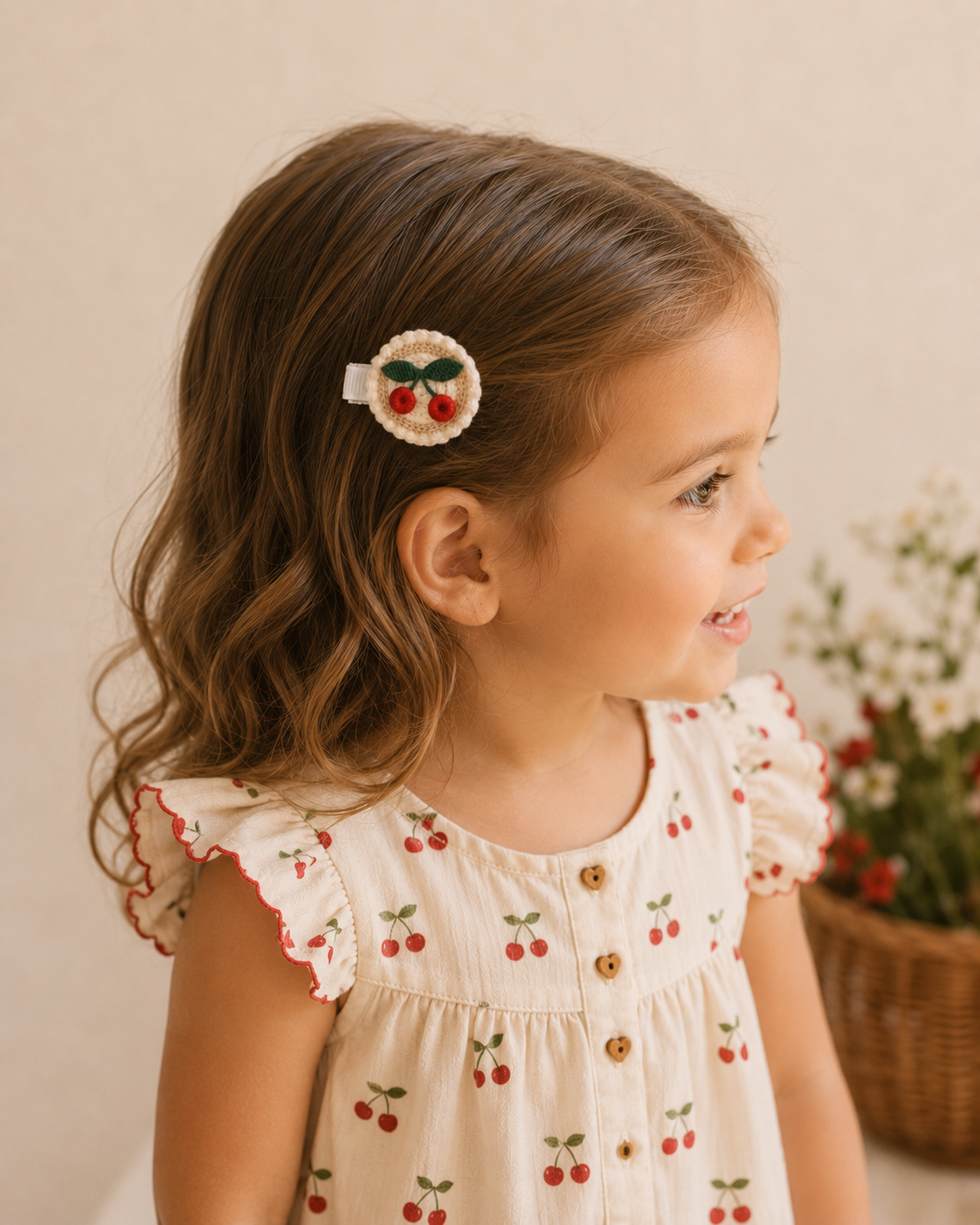 toddler girl wearing an embroidered cherry hair clip.